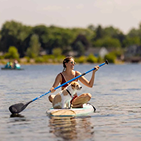 paddle board with a girl and dog